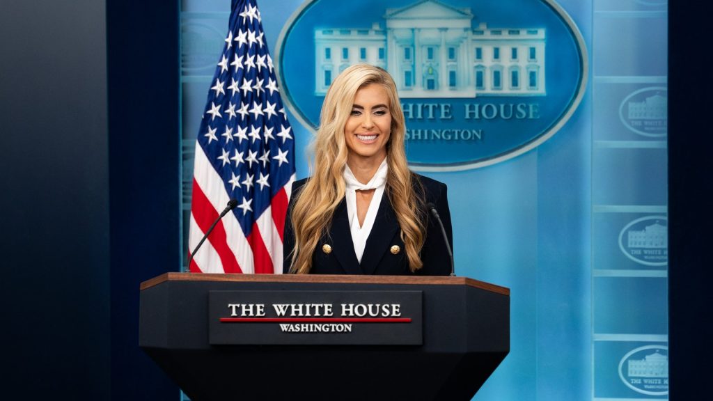 Katie Zacharia speaking at the White House briefing room podium