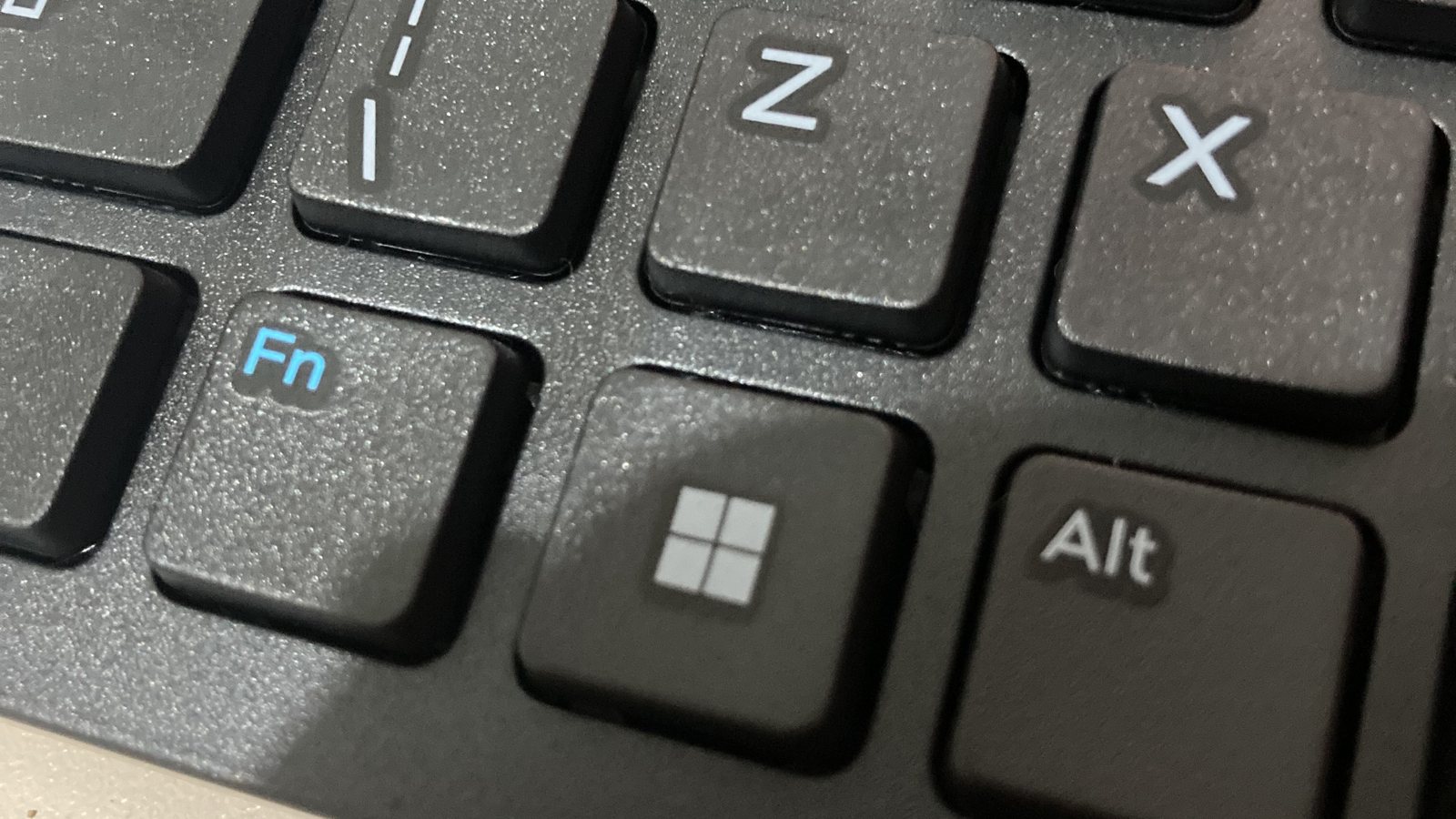 Close-up of a black keyboard showing the Windows key between the Fn and Alt keys, below the Z and X keys