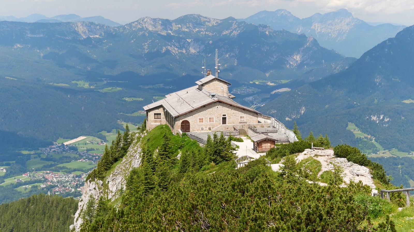 The stone Kehlsteinhaus, or Eagle's Nest, on a forested ridge above Berchtesgaden with Alpine peaks behind